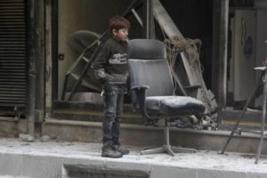 A boy inspects damage after airstrikes by pro-Syrian government forces in the rebel held Al-Shaar neighborhood of Aleppo, Syria February 4, 2016. REUTERS/Abdalrhman Ismail