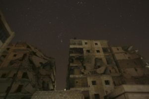 Damaged buildings are pictured at night in Aleppo, Syria December 11, 2015. REUTERS/Ammar Abdullah