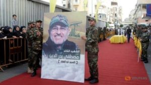 Hezbollah members carry a picture of top Hezbollah commander Mustafa Badreddine during his funeral in Beirut's southern suburbs