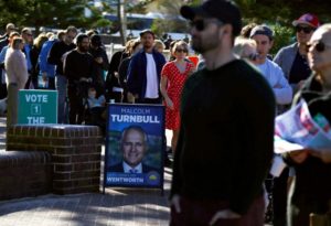 Voters stand in a line as they enter the voting station located in the South Bondi Lifesaving Club, at Sydney's Bondi Beach, Australia
