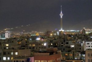 View shows Tehran's skyline at night with the Milad tower