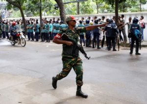 A security personnel reacts near the Holey Artisan restaurant after gunmen attacked the upscale cafe, in Dhaka