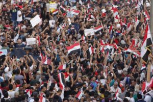People shout slogans during a demonstration at Tahrir Square in central Baghdad