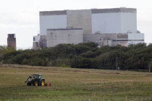 A tractor mows a field on the site where EDF Energy's Hinkley Point C nuclear power station will be constructed in Bridgwater, southwest England October 24, 2013