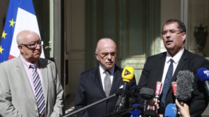The head of France's top Muslim body Anouar Kbibech (right) speaks to journalists alongside his deputy Abdallah Zekri (left) and France's Interior Minister Bernard Cazeneuve in Paris on August 1, 2016.