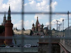 A view through a construction fence shows the Kremlin towers and St. Basil's Cathedral in Moscow. (Maxim Zmeyev/Reuters)