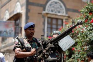 Soldiers hold a machine gun mounted on a police truck outside Yemen’s Parliament during a session held by parliament for the first time since the start of the civil war two years ago in Sana’a, August 13.