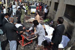 People comfort each other following a bomb blast in Quetta, Pakistan, Monday, Aug. 8, 2016. Arshad Butt, AP