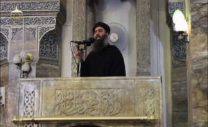 A man purported to be the reclusive leader of the militant Islamic State Abu Bakr al-Baghdadi has made what would be his first public appearance at a mosque in the centre of Iraq's second city, Mosul, according to a video recording posted on the Internet on July 5, 2014, in this still image taken from video. There had previously been reports on social media that Abu Bakr al-Baghdadi would make his first public appearance since his Islamic State in Iraq and the Levant (ISIL) changed its name to the Islamic State and declared him caliph. The Iraqi government denied that the video, which carried Friday's date, was credible. It was also not possible to immediately confirm the authenticity of the recording or the date when it was made. REUTERS/Social Media Website via Reuters TV (IRAQ - Tags: POLITICS) ATTENTION EDITORS - THIS IMAGE HAS BEEN SUPPLIED BY A THIRD PARTY. IT IS DISTRIBUTED, EXACTLY AS RECEIVED BY REUTERS, AS A SERVICE TO CLIENTS. REUTERS IS UNABLE TO INDEPENDENTLY VERIFY THE CONTENT OF THIS VIDEO, WHICH HAS BEEN OBTAINED FROM A SOCIAL MEDIA WEBSITE - RTR3X9AW