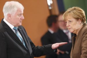 Bavarian Prime Minister and head of the Christian Social Union Horst Seehofer talks with German Chancellor Angela Merkel prior to a meeting of German state leaders to discuss the migrant crisis, in Berlin in this December 3,2015 file picture. REUTERS/Hannibal Hanschke/Files