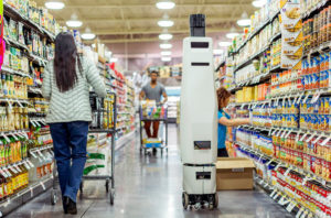 A Bossa Nova robot gliding through a store aisle to check inventory.