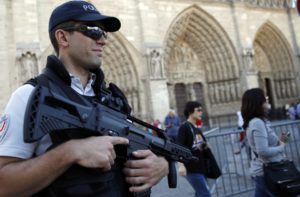 A French police officer patrols in front of Notre Dame cathedral in Paris Friday Sept 9, 2016- AP