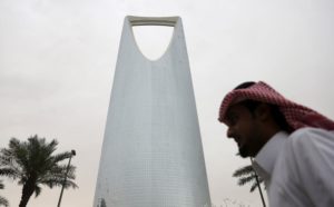 Man walks past the Kingdom Centre Tower in Riyadh