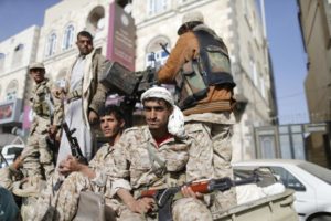 Houthi fighters ride a truck while patrolling a street in Sanaa