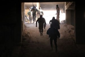 Rebel fighters from the Jaish al-Fatah (or Army of Conquest) brigades gather in position at an entrance to Aleppo, in the southwestern frontline near the neighbourhood of Dahiyet al-Assad, on November 3, 2016