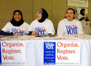 Farhana Quayoum (L), Angel Ouza (C) and Rhima Aoun volunteer at a rally encouraging Arab-Americans to register and vote during this Saturday's democratic presidential caucus, in Dearborn, Michigan February 4, 2004. Arab-Americans across the country have been holding similar registration drives to mobilize political power. - RTXMFJ7