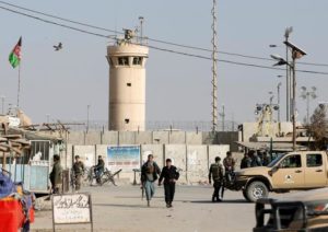Afghan National Army (ANA) soldiers and police keep watch outside the Bagram Airfield entrance gate, after an explosion at the NATO air base, north of Kabul