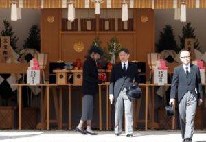 Japan's Crown Prince Naruhito and Crown Princess Masako walk after praying at the altar during the funeral of late Prince Mikasa, uncle of the current Emperor Akihito, at the Toshimagaoka cemetery in Tokyo