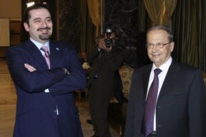 Lebanon's Parliament majority leader al-Hariri and Lebanese opposition Christian leader Aoun smile during the sixth session of the national dialogue between politician rival leaders in Baabda