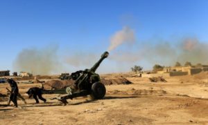 Iraqi army fires towards Islamic State militant positions in Mosul from the village of Adhbah