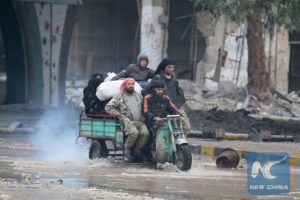 People ride a tricycle as they flee deeper into the remaining rebel-held areas of Aleppo, Syria December 7, 2016.