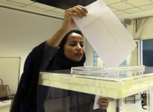 A Saudi woman casts her ballot at a polling center during municipal elections in Riyadh, Saudi Arabia, Saturday, Dec. 12.