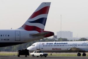 An Iranian Aseman Airlines' Fokker 100 prepares to take off as a British Airways aeroplane is seen in the foreground at Tehran's Mehrabad airport