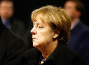 German Chancellor Angela Merkel reacts before she signs the condolence book at the Gedaechniskirche in Berlin