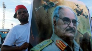 Haftar supporter holds his picture in Benghazi [Reuters]