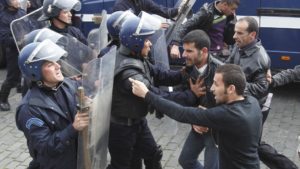 Riot police break up a previous protest in Algeria.