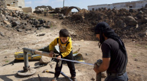 Civilians fix damaged water pipes in the rebel held al-Ghariyah al-Gharbiyah town, in Deraa province, Syria February 28, 2016.