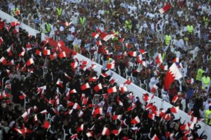 In this Friday, Sept. 30, 2011 file photo, Bahraini anti-government protesters wave flags and chant during a rally of thousands organized by Al-Wefaq.