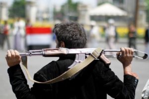 An armed man loyal to the Houthi movement holds his weapon as he gathers to protest against the elected government deciding to cut off the Yemeni central bank from the outside world, in the capital Sanaa, Yemen August 25, 2016.