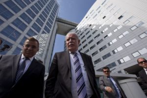 Palestinian Authority Foreign Minister Riyad Malki, center, waits on the steps of the International Criminal Court after answering questions of reporters in The Hague, Netherlands, Thursday, June 25, 2015.