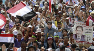Members of the Muslim Brotherhood and supporters of deposed Egyptian President Mohammed Morsi shout slogans at Rabia al-Adawiya Square in the northeast Cairo suburb of Nasr City, July 8, 2013.