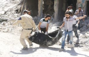 Syrians evacuate a body from the rubble of a building following air strikes in Aleppo’s rebel-held neighborhood of Tariq Al-Bab. — AFP