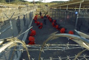 File photo of detainees sitting in a holding area at Naval Base Guantanamo Bay