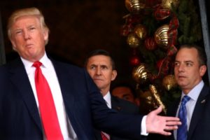 Incoming White House Chief of Staff Reince Priebus and U.S. Army Lieutenant General Michael Flynn look at U.S. President-elect Donald Trump as he talks with the media at Mar-a-Lago estate where Trump attends meetings, in Palm Beach, Florida