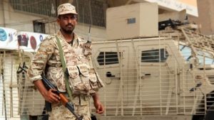Yemeni army soldier stands guard as he secures a street in Mansoura district of Yemen's southern port city of Aden