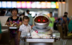 A robotic waiter carries food in a restaurant in Kunshan, China. (2014 photo by Johannes Eisele/Agence France-Presse via Getty Images)
