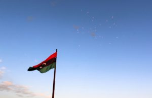 A Libyan flag flies as fireworks explode during celebrations after Libyan forces allied with the U.N.-backed government finished clearing Ghiza Bahriya, the final district of the former ISIS stronghold of Sirte, Libya, on Dec. 6, 2016. Photo by Hani Amara/Reuters