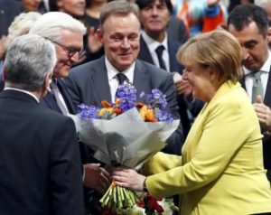 German president-elect, Frank-Walter Steinmeier, receives congratulations by German Chancellor Angela Merkel after the first round of voting of the German presidential election at the Reichstag in Berlin, February 12, 2017.REUTERS/Fabrizio Bensch