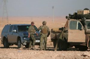 U.S. fighters stand near military vehicles, north of Raqqa city, Syria November 6, 2016