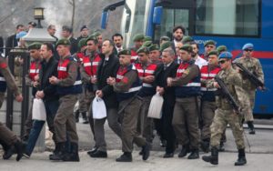 Turkish soldiers accused of attempting to assassinate President Erdogan on the night of the failed July 15 coup, are escorted by gendarmes as they arrive for the first hearing of the trial in Mugla
