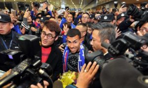 Carlos Tevez is surrounded by fans as he arrives in Shanghai on 19 January 2017. Photograph: Xinhua / Barcroft Images