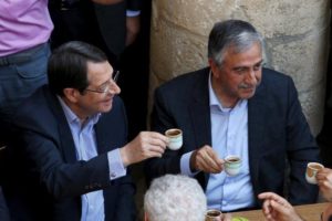 FILE PHOTO: Turkish Cypriot leader Mustafa Akinci (R) and Greek Cypriot leader, Cypriot President Nicos Anastasiades, drink coffee in old Nicosia