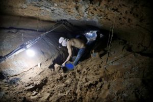 FILE PHOTO: Palestinian worker repairs a smuggling tunnel after it was flooded by Egyptian security forces, beneath the border between Egypt and southern Gaza Strip