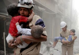 Members of the Civil Defense rescue children after what activists said was an air strike by forces loyal to Syria's Bashar Assad in al-Shaar neighborhood of Aleppo, Syria June 2, 2014.