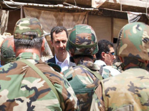 Syria's long-time despot Bashar al-Assad chats with military personnel during his visit to a military site in the town of Daraya, southwest of Damascus REUTERS/SANA/Handout via Reuters
