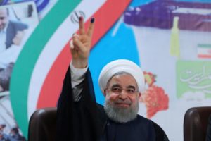 FILE PHOTO: Iran's President Hassan Rouhani gestures as he registers to run for a second four-year term in the May election, in Tehran, Iran